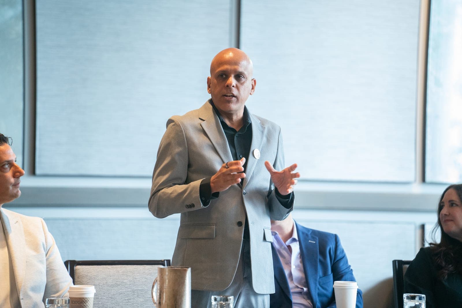 Manuj Aggarwal speaking at a session, mid-gesture.
